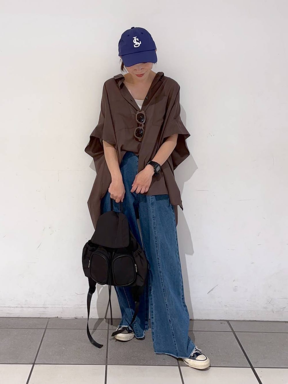 ブルー系のデニムパンツ、ホワイト系のキャミソール、ブラウン系のシャツ/ブラウスを着用したレディースの夏コーディネートの5枚目の写真