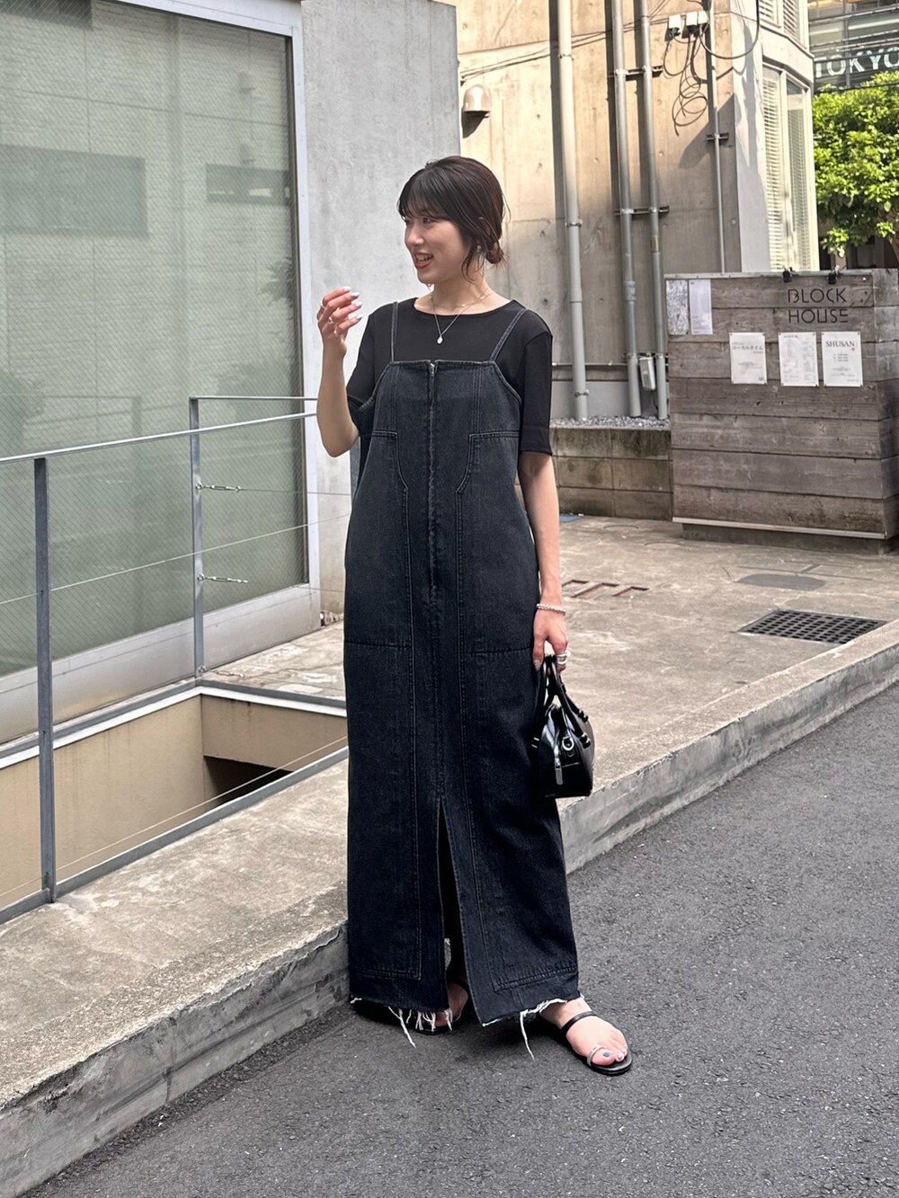 ブルー系のワンピース、ブラック系のTシャツ/カットソー、ブラック系のバッグを着用したレディースの夏コーディネートの4枚目の写真