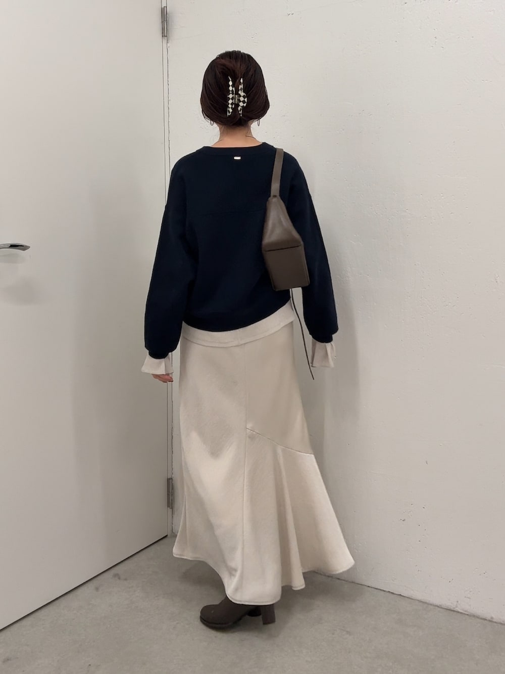 ブルー系のニット/セーター、ホワイト系のTシャツ/カットソー、ホワイト系のスカートを着用したレディースの冬コーディネートの3枚目の写真