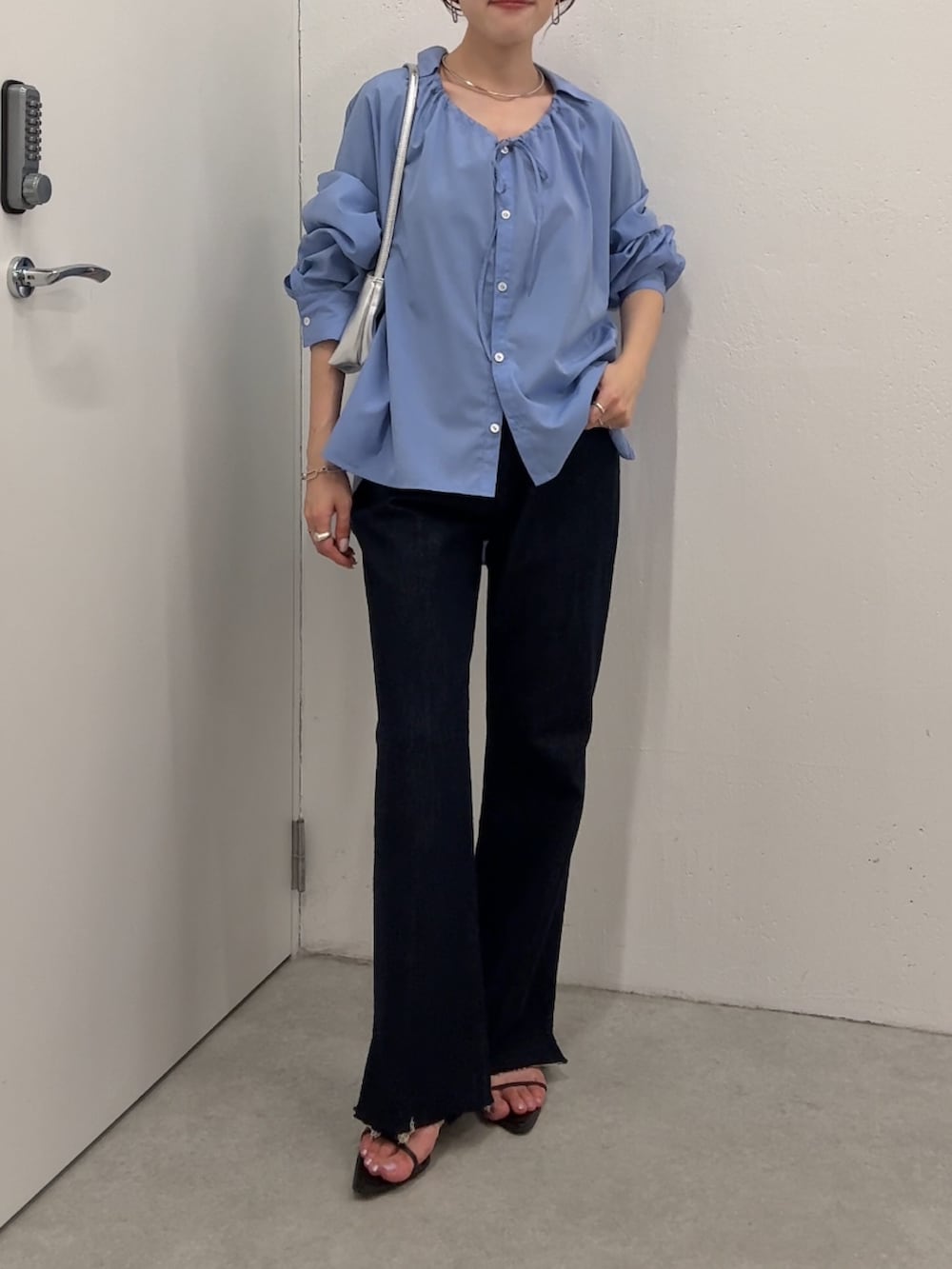 ブルー系のシャツ/ブラウス、ブルー系のデニムパンツ、シルバー系のショルダーバッグを着用したレディースの夏コーディネートの4枚目の写真