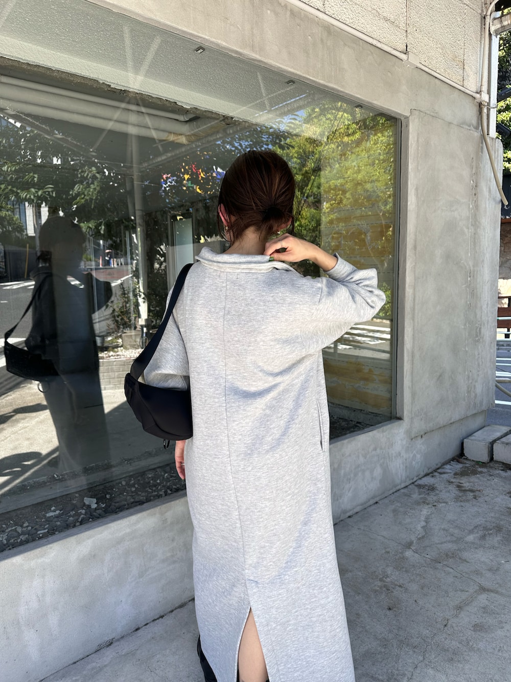 グレー系のワンピース、ブラック系のボディバッグ/ウエストポーチ、ブラック系のブーツを着用したレディースの夏コーディネートの2枚目の写真