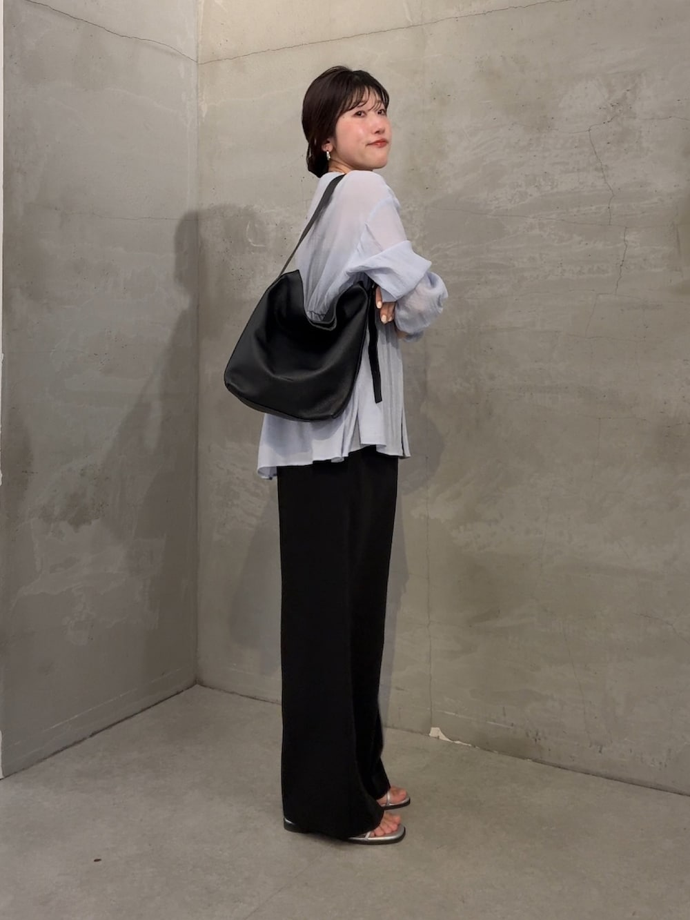 ブルー系のシャツ/ブラウス、ブラック系のスラックスを着用したレディースの冬コーディネートの4枚目の写真