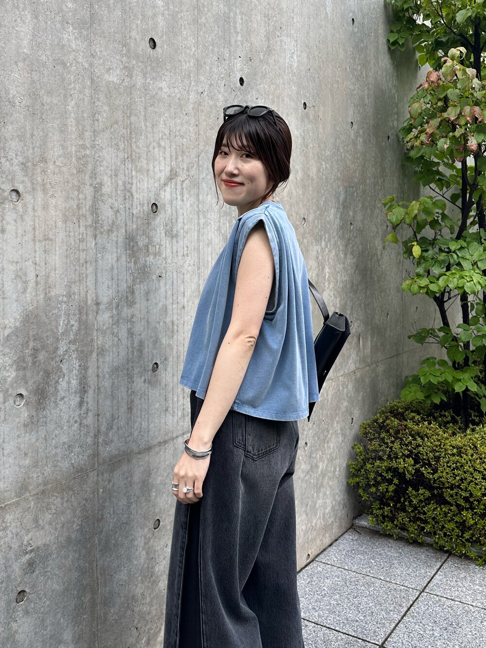 ブルー系のTシャツ/カットソー、ブラック系のデニムパンツ、ブラック系のバッグを着用したレディースの夏コーディネートの5枚目の写真