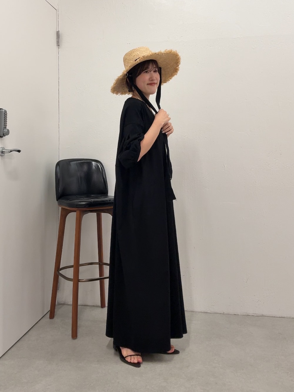 ブラック系のワンピース、ブラック系のトートバッグを着用したレディースの春コーディネートの4枚目の写真