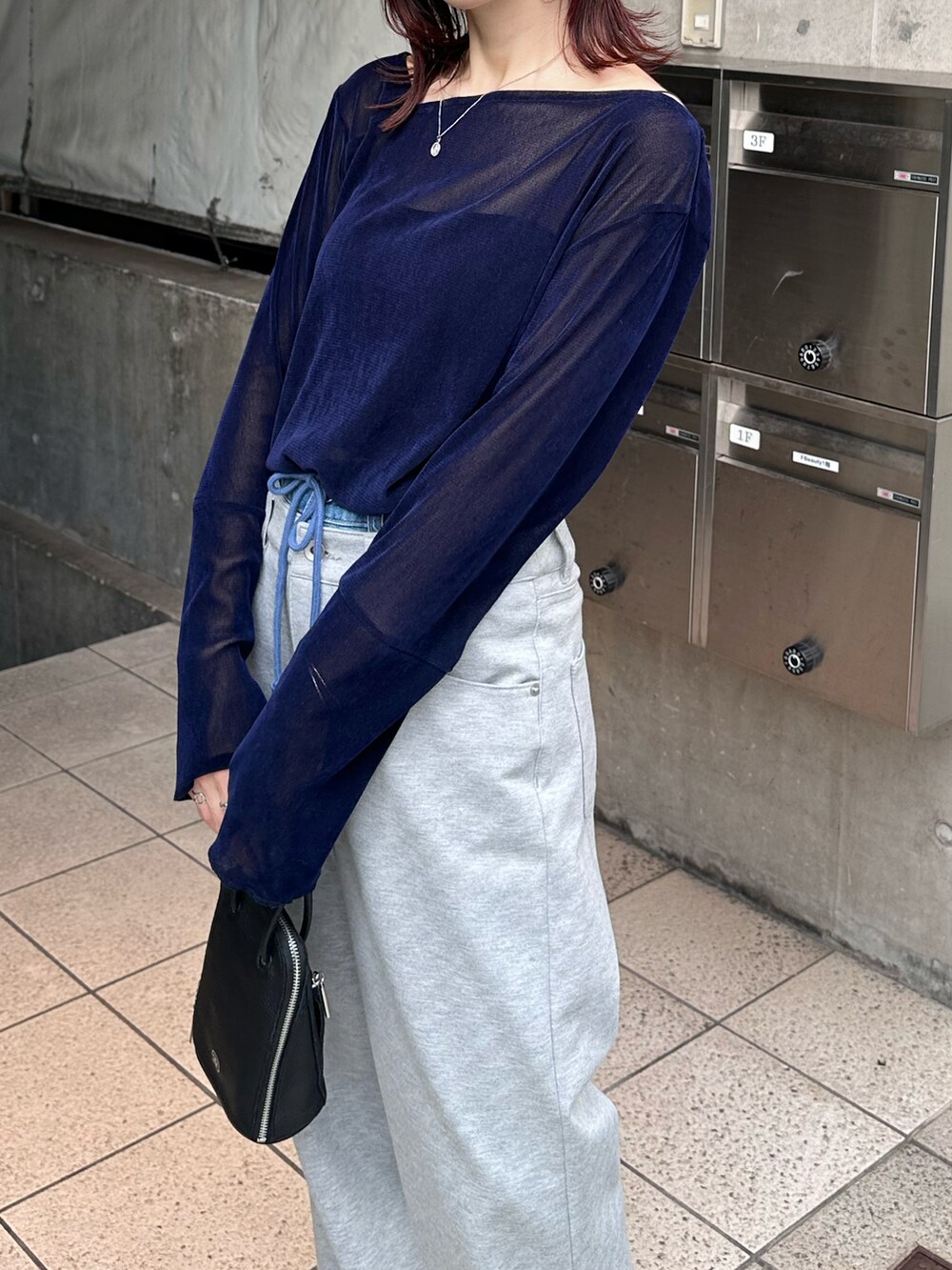 ブルー系のTシャツ/カットソー、グレー系のデニムパンツを着用したレディースの夏コーディネートの2枚目の写真