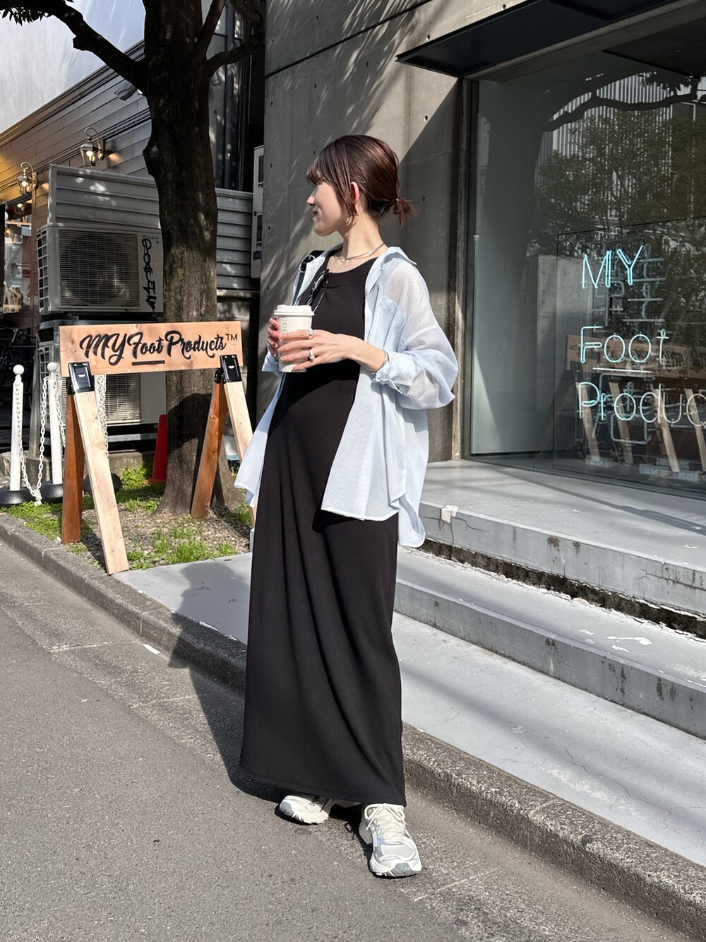 ブラック系のワンピース、ブルー系のシャツ/ブラウス、ブラック系のバッグを着用したレディースの春コーディネートの3枚目の写真