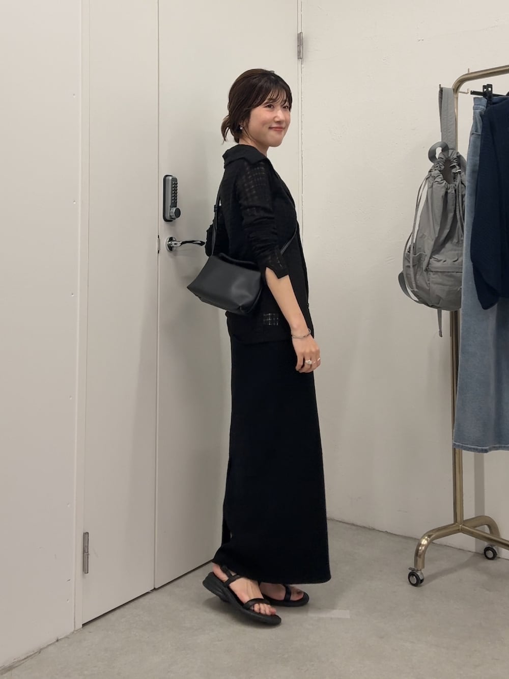 ブラック系のカーディガン/ボレロ、ブラック系のワンピース、ブラック系のショルダーバッグを着用したレディースの夏コーディネートの2枚目の写真