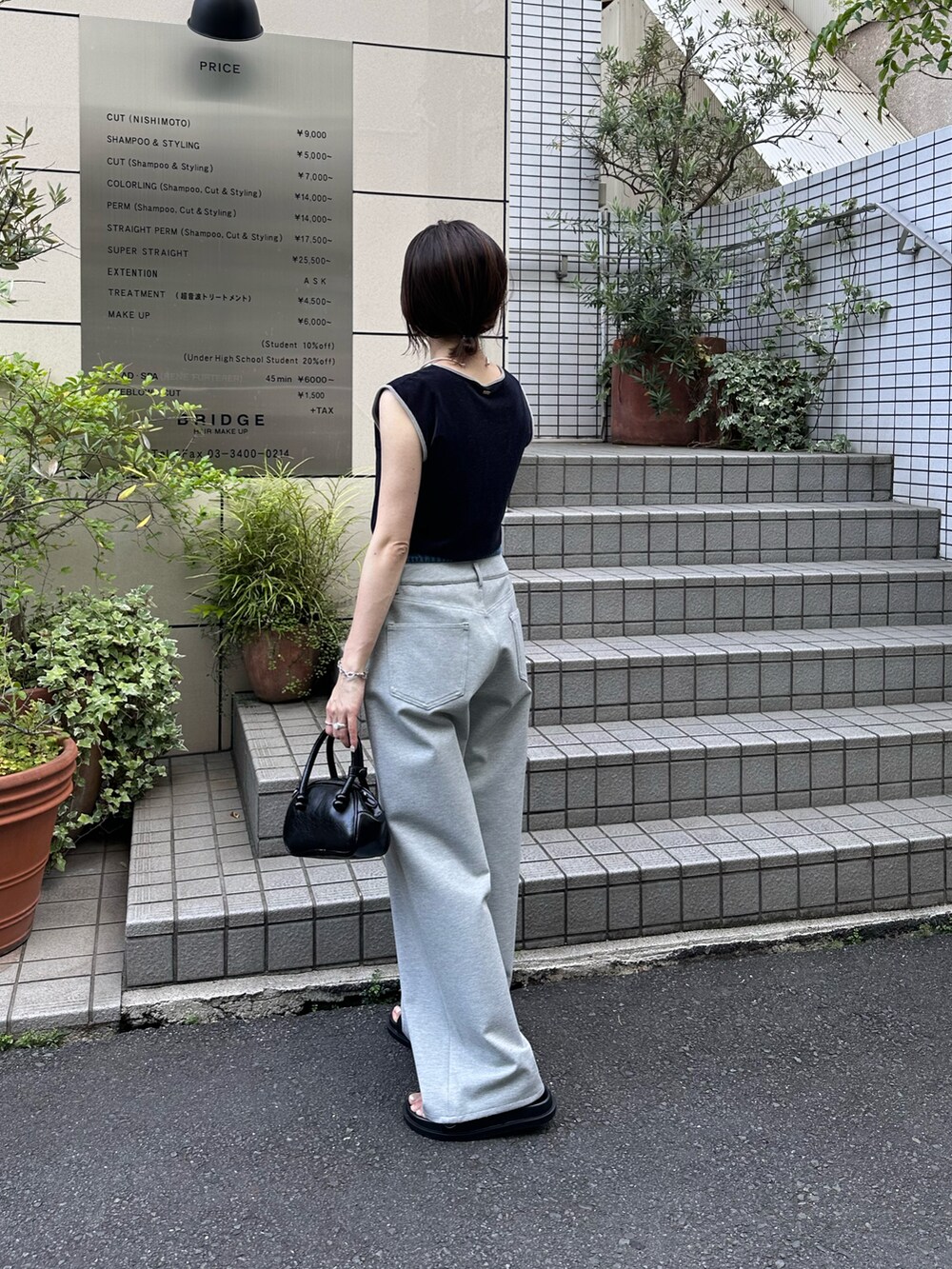 ブルー系のTシャツ/カットソー、グレー系のデニムパンツ、ブラック系のバッグを着用したレディースの夏コーディネートの3枚目の写真