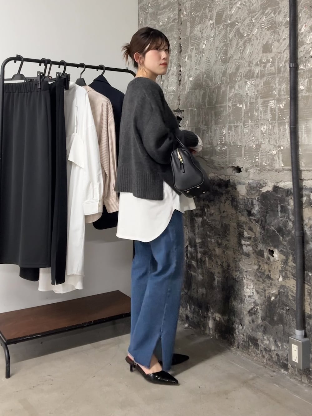 グレー系のニット/セーター、ホワイト系のTシャツ/カットソー、ブラック系のボストンバッグを着用したレディースの夏コーディネートの3枚目の写真