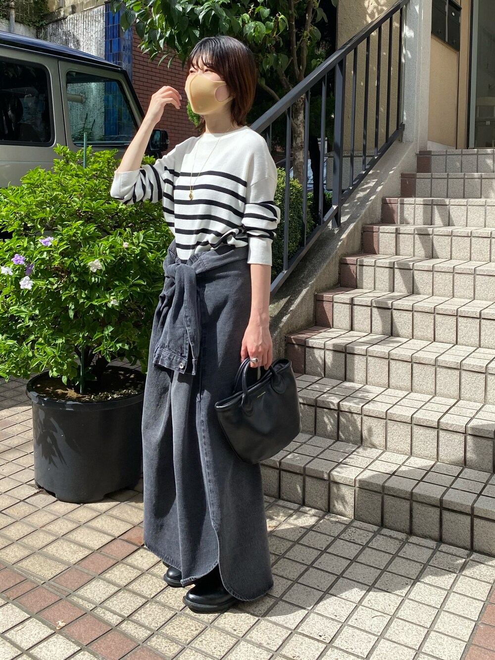 ホワイト系のニット/セーター、ブラック系のシャツワンピース、ブラック系のブーツを着用したレディースの夏コーディネートの5枚目の写真