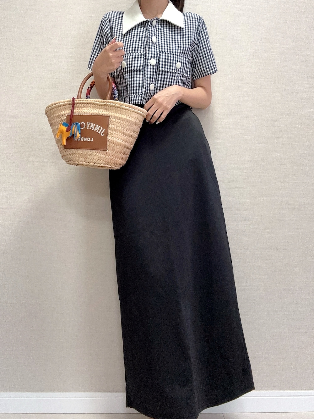 ブルー系のシャツ/ブラウス、ブラック系のスカート、ブラウン系のかごバッグを着用したレディースの夏コーディネートの2枚目の写真