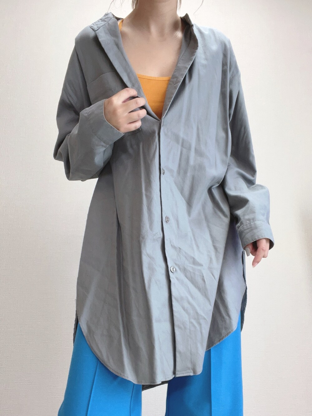 グレー系のシャツ/ブラウス、オレンジ系のチューブトップ、ブルー系のその他パンツを着用したレディースの冬コーディネートの3枚目の写真