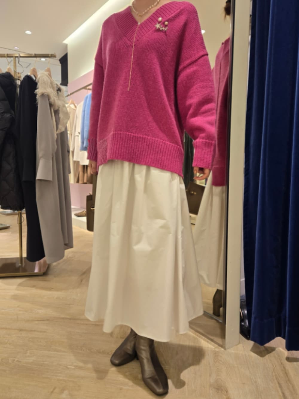 ホワイト系のスカート、ベージュ系のショルダーバッグ、ピンク系のニット/セーターを着用したレディースの秋コーディネートの5枚目の写真