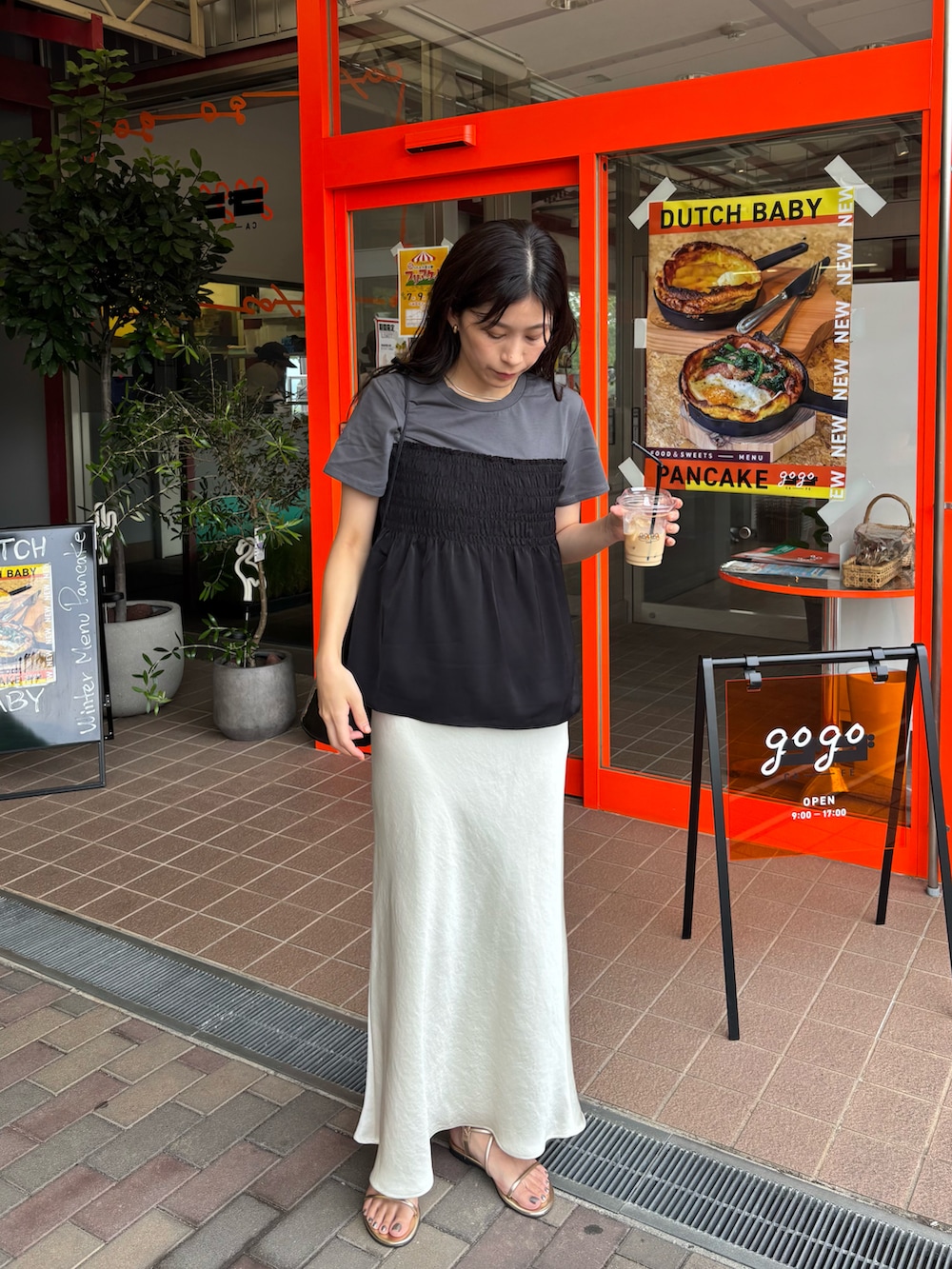 ホワイト系のスカート、グレー系のTシャツ/カットソーを着用したレディースの夏コーディネートの2枚目の写真