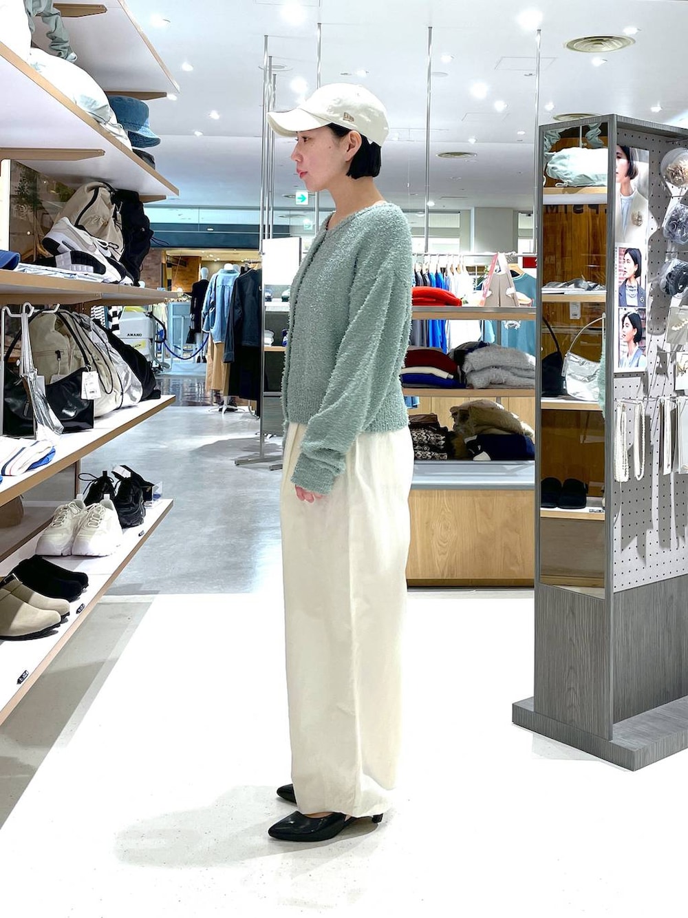 グリーン系のカーディガン/ボレロ、ホワイト系のその他パンツ、ブラック系のパンプスを着用したレディースの冬コーディネートの3枚目の写真