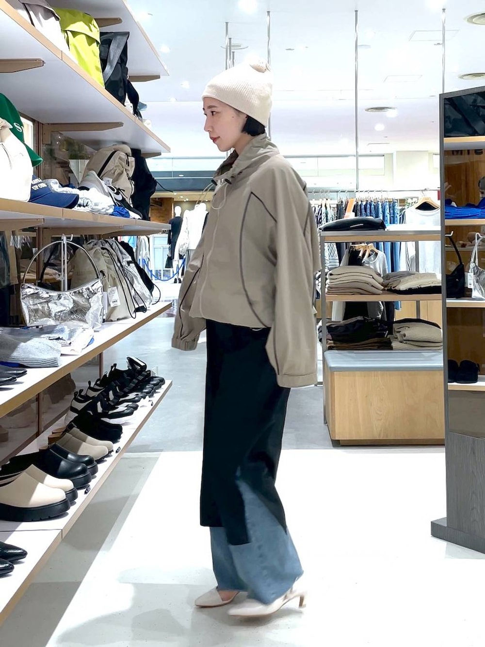 ブラック系のスカート、ブルー系のデニムパンツ、ベージュ系のその他アウターを着用したレディースの冬コーディネートの3枚目の写真