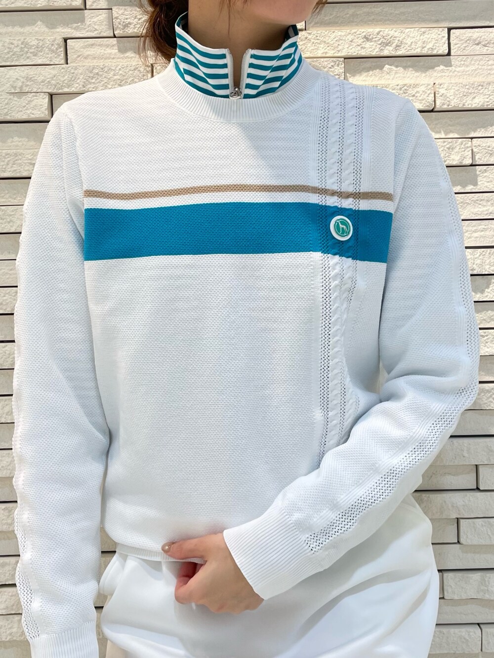 ホワイト系のスカート、ホワイト系のニット/セーター、ブルー系のトートバッグを着用したレディースの春コーディネートの3枚目の写真