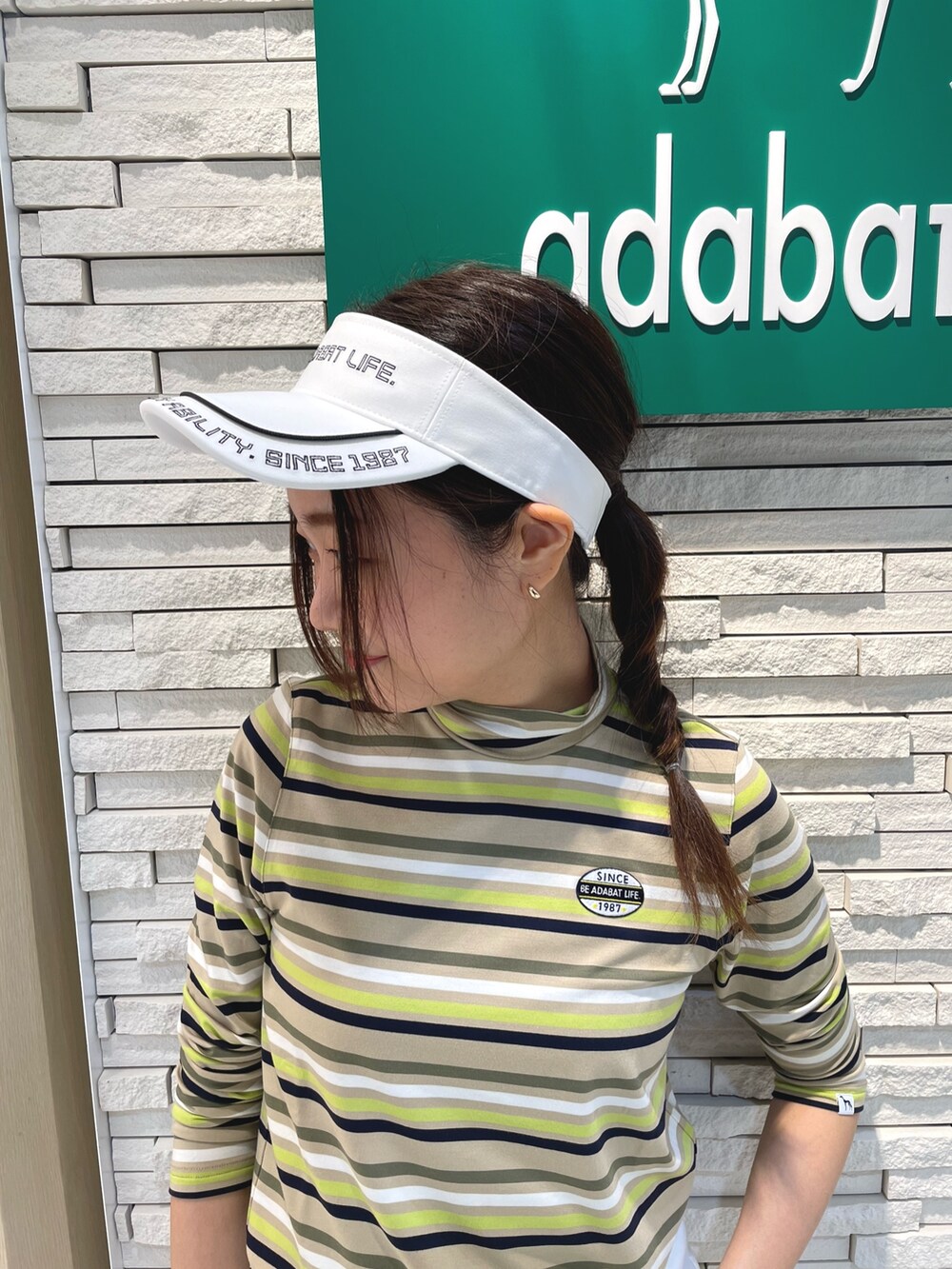 ホワイト系のダウンジャケット/コート、ホワイト系のスカート、グリーン系のトートバッグを着用したレディースの冬コーディネートの5枚目の写真