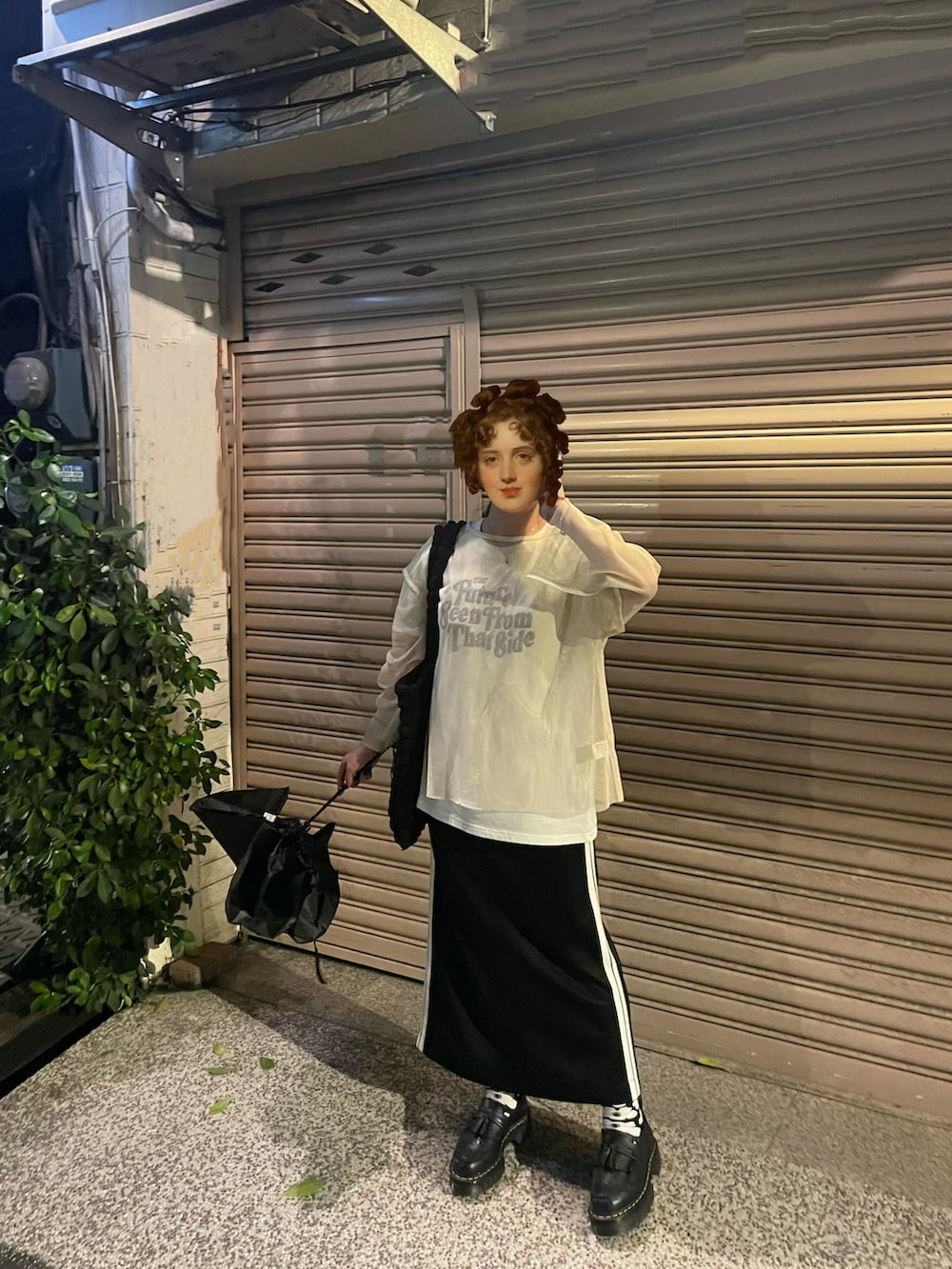 ベージュ系のトップス、ベージュ系のTシャツ/カットソー、ブラック系のスカートを着用したレディースの春コーディネートの2枚目の写真