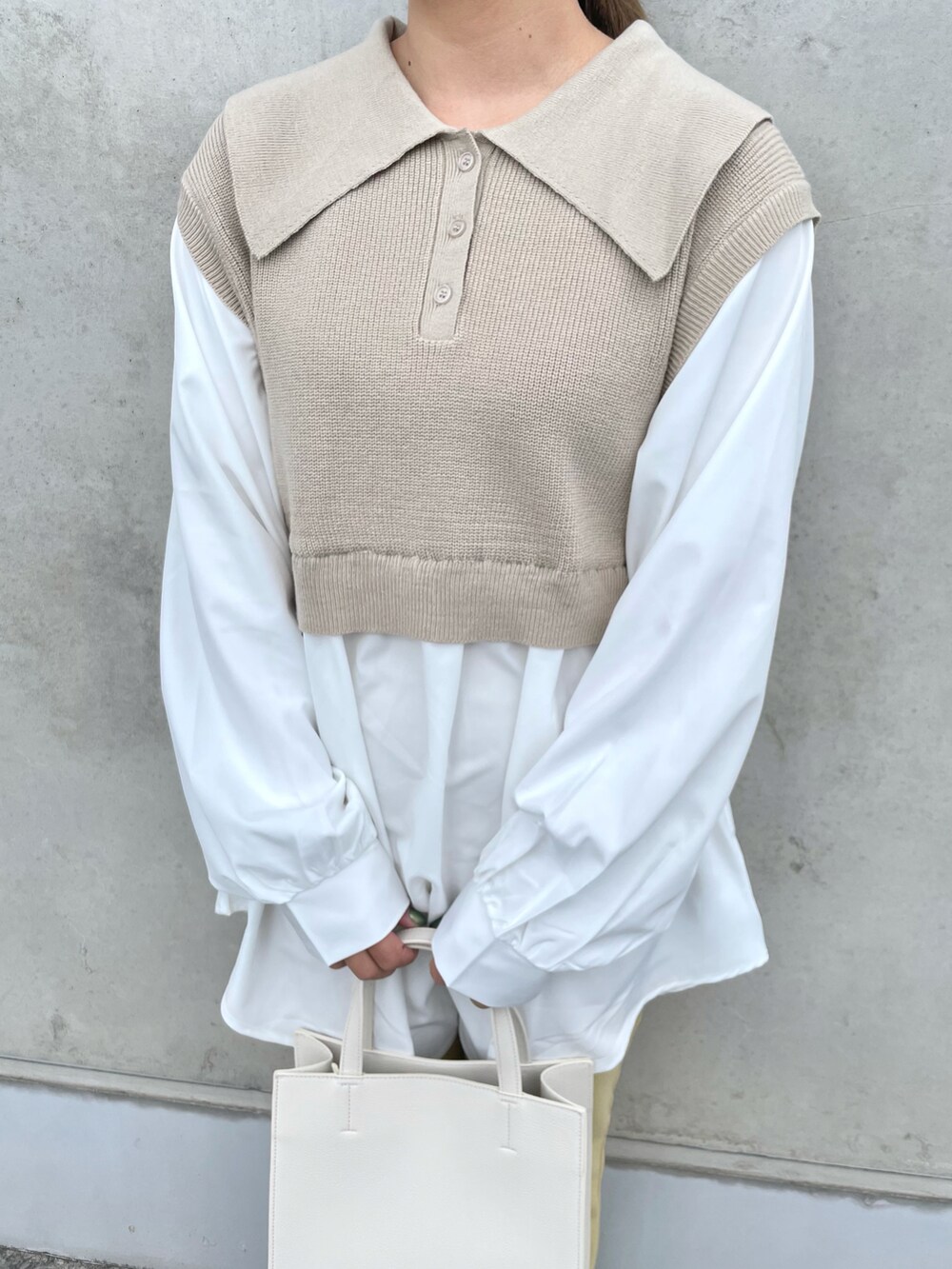 ベージュ系のトップス、その他のバッグ、ゴールド系のシューズを着用したレディースの冬コーディネートの2枚目の写真