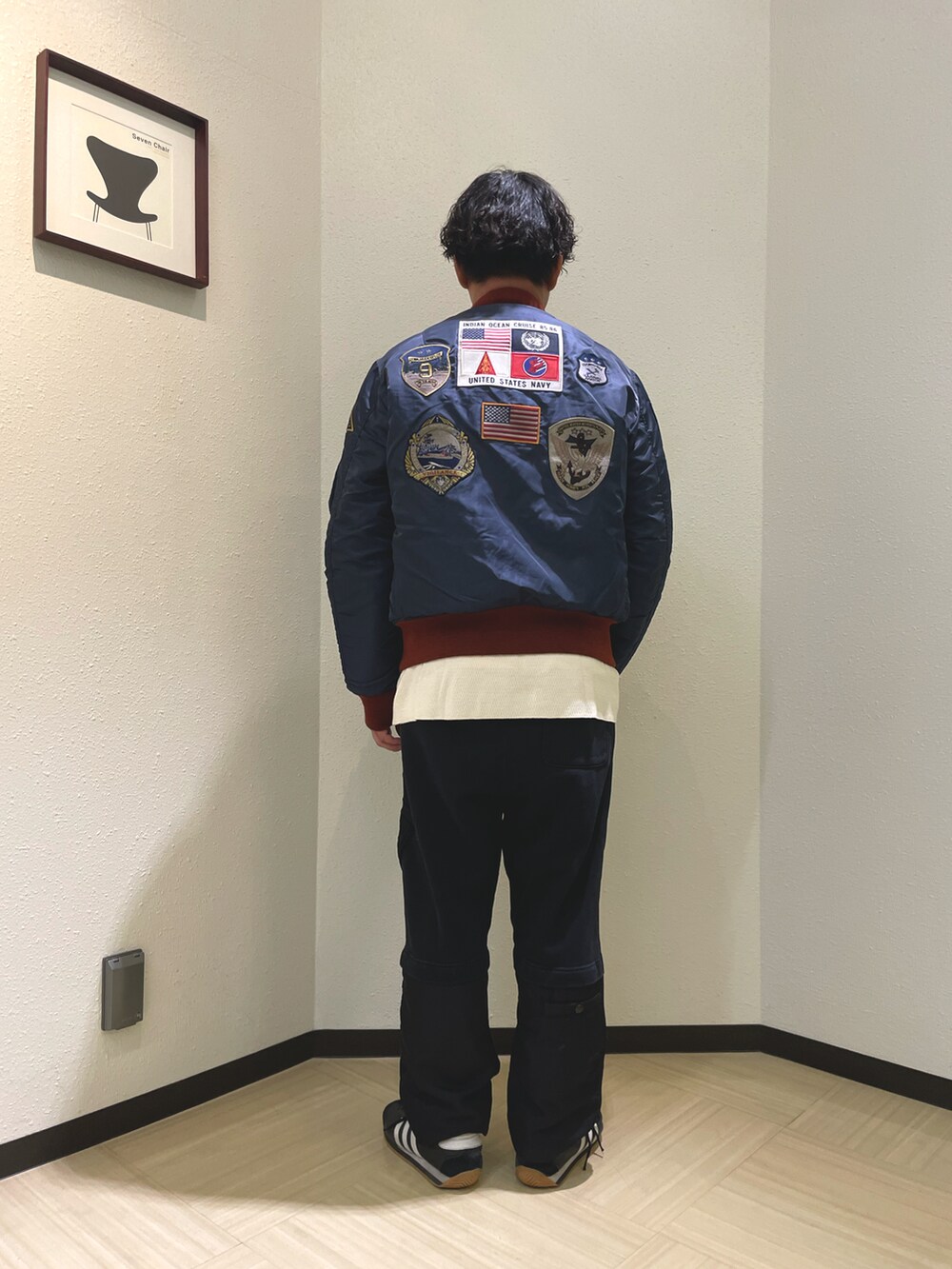 ブルー系のMA-1、ベージュ系のTシャツ/カットソー、ブラック系のスウェットパンツを着用したメンズの秋コーディネートの2枚目の写真