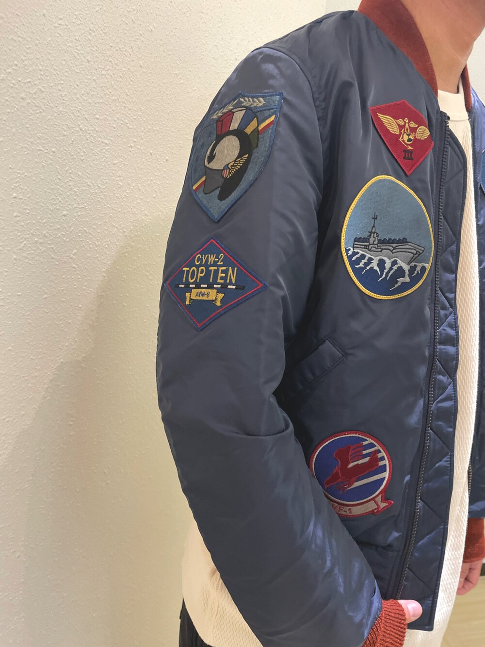 ブルー系のMA-1、ベージュ系のTシャツ/カットソー、ブラック系のスウェットパンツを着用したメンズの秋コーディネートの5枚目の写真