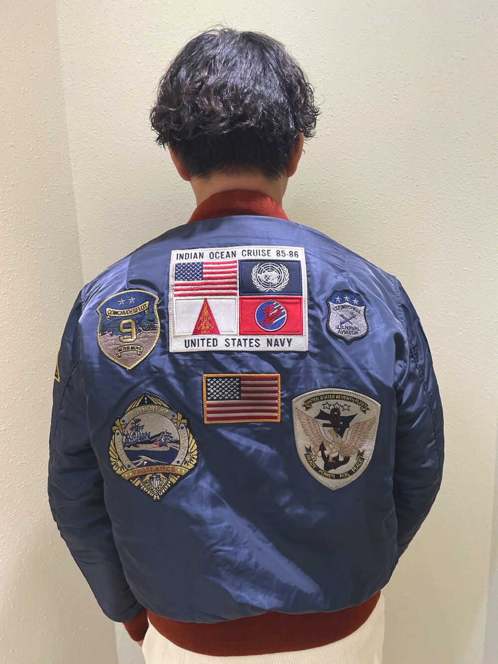 ブルー系のMA-1、ベージュ系のTシャツ/カットソー、ブラック系のスウェットパンツを着用したメンズの秋コーディネートの3枚目の写真