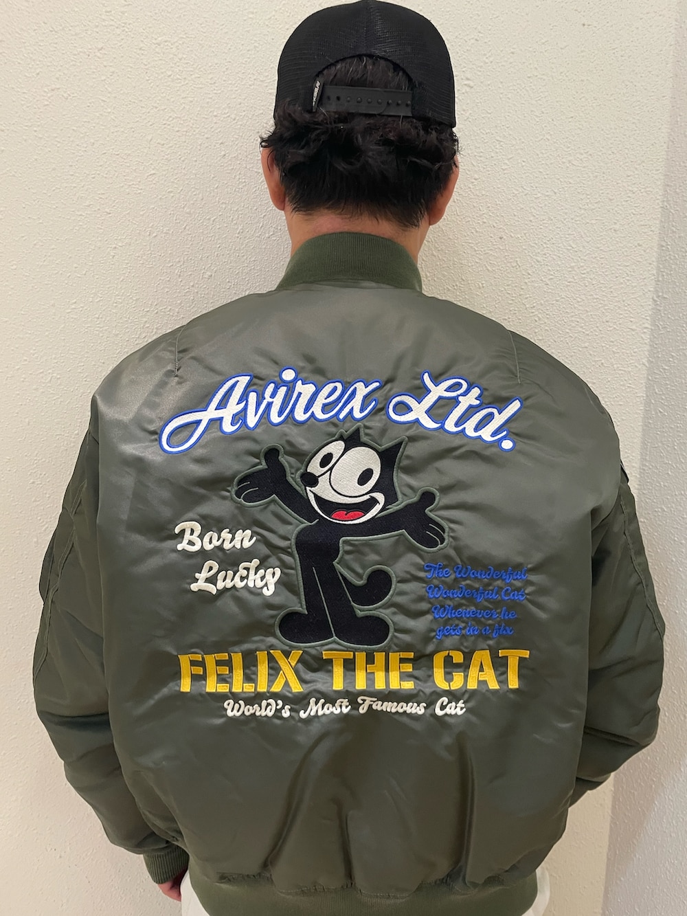 グレー系のカーゴパンツ、グリーン系のMA-1、ブラック系のキャップを着用したメンズの冬コーディネートの3枚目の写真