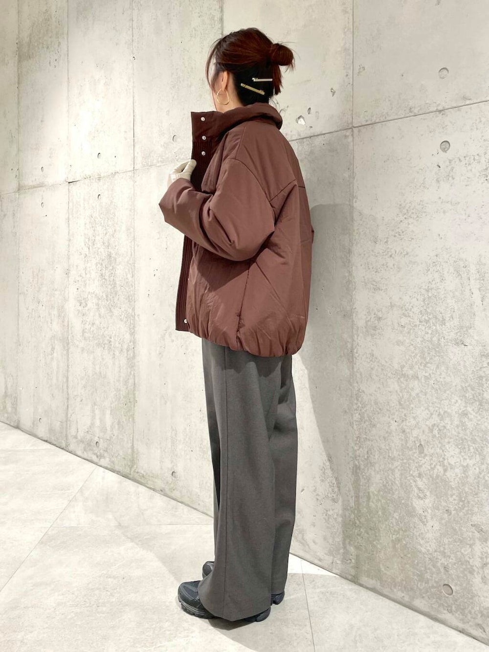 ブラウン系のブルゾン、ホワイト系のTシャツ/カットソー、ホワイト系のニット/セーターを着用したレディースの冬コーディネートの5枚目の写真