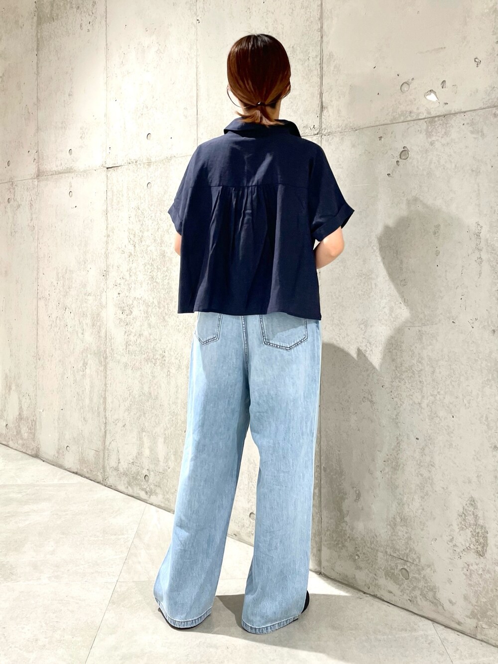 ブルー系のデニムパンツ、ブラック系のサンダル、ブルー系のシャツ/ブラウスを着用したレディースの夏コーディネートの3枚目の写真
