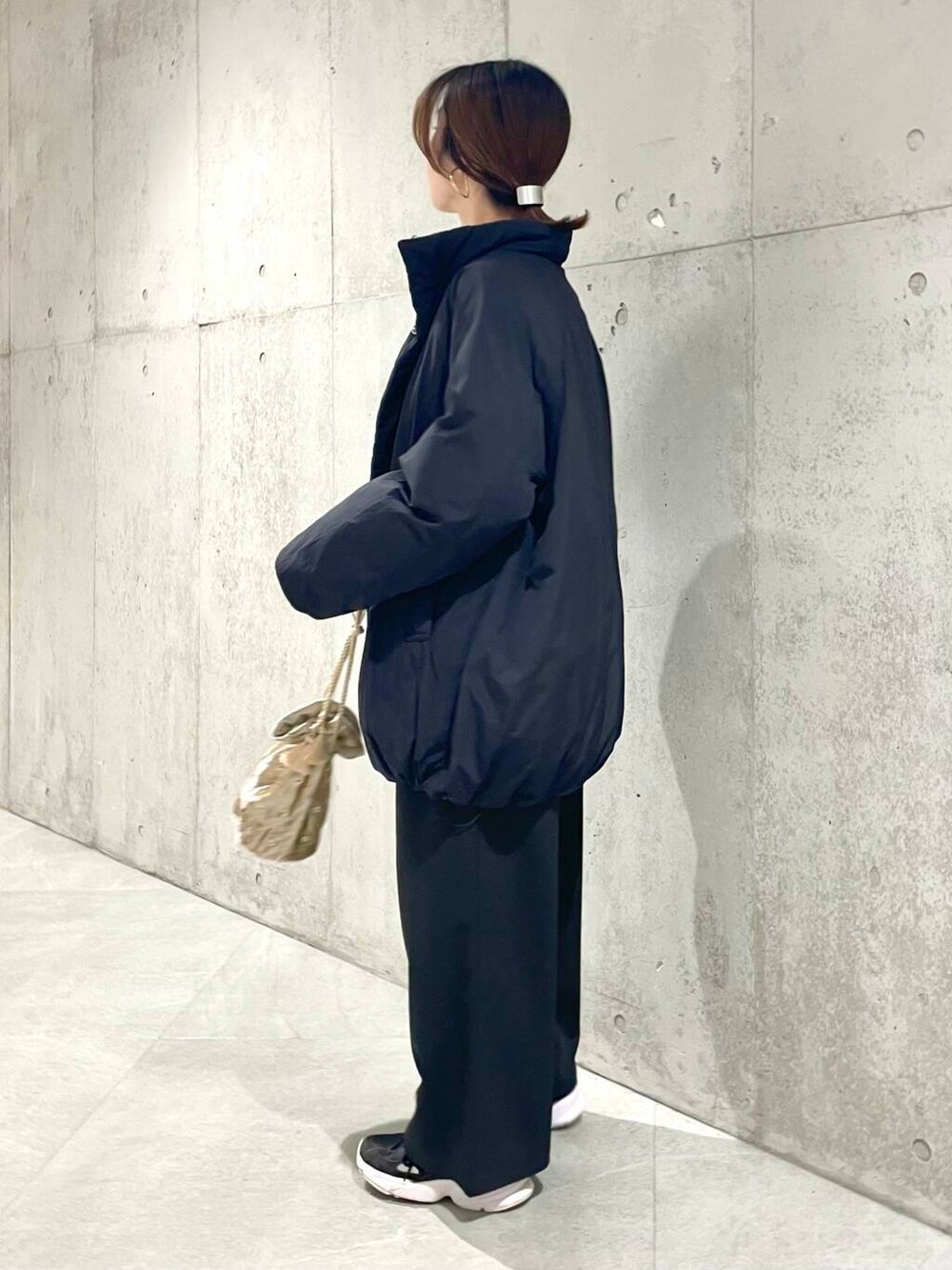 ブラック系のブルゾン、ブラック系のその他パンツ、ホワイト系のTシャツ/カットソーを着用したレディースの秋コーディネートの3枚目の写真