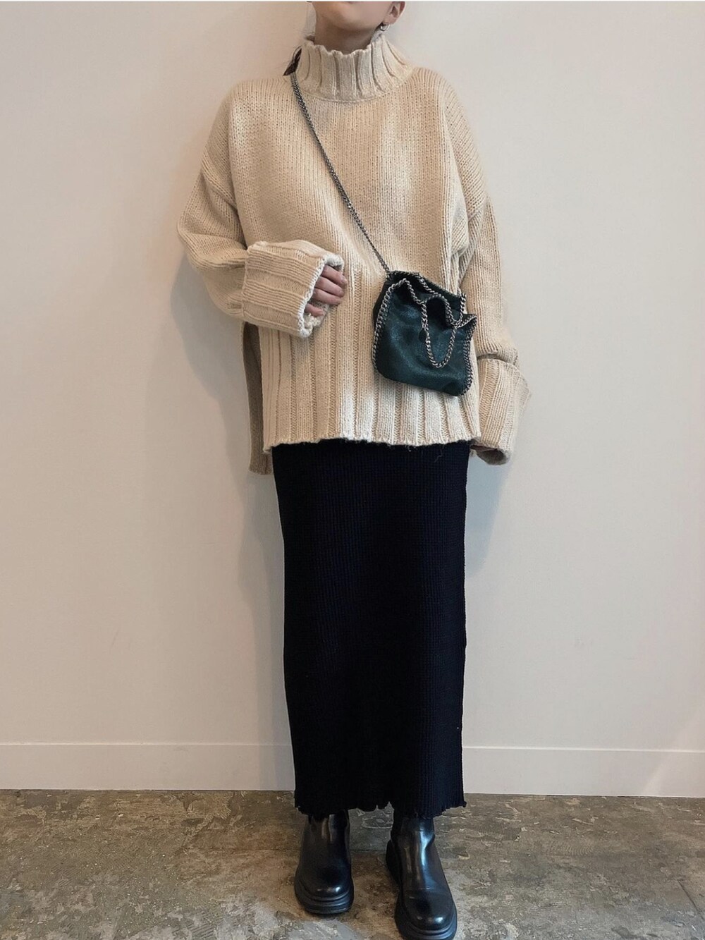 ホワイト系のニット/セーターを着用したレディースの冬コーディネートの2枚目の写真