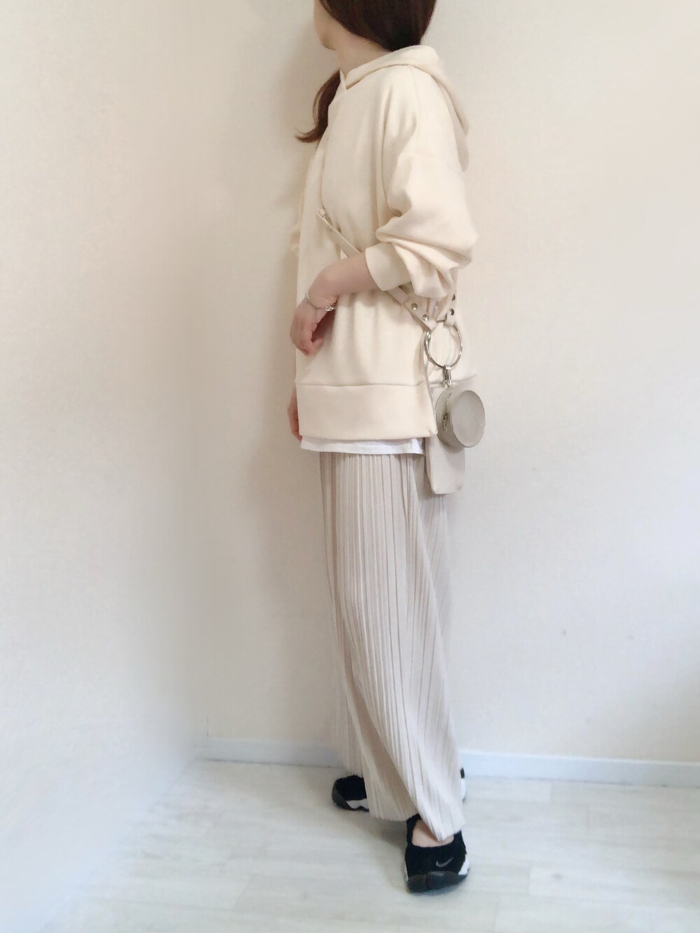 ホワイト系のパーカー、ホワイト系のその他パンツ、ホワイト系のショルダーバッグを着用したレディースの春コーディネートの3枚目の写真