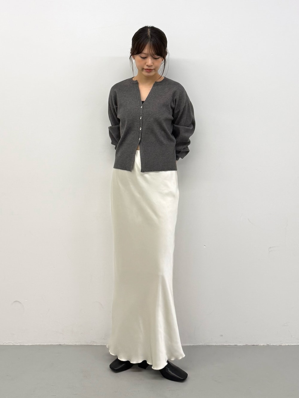 グレー系のカーディガン/ボレロ、グレー系のカーディガン/ボレロ、ホワイト系のスカートを着用したレディースの秋コーディネートの2枚目の写真