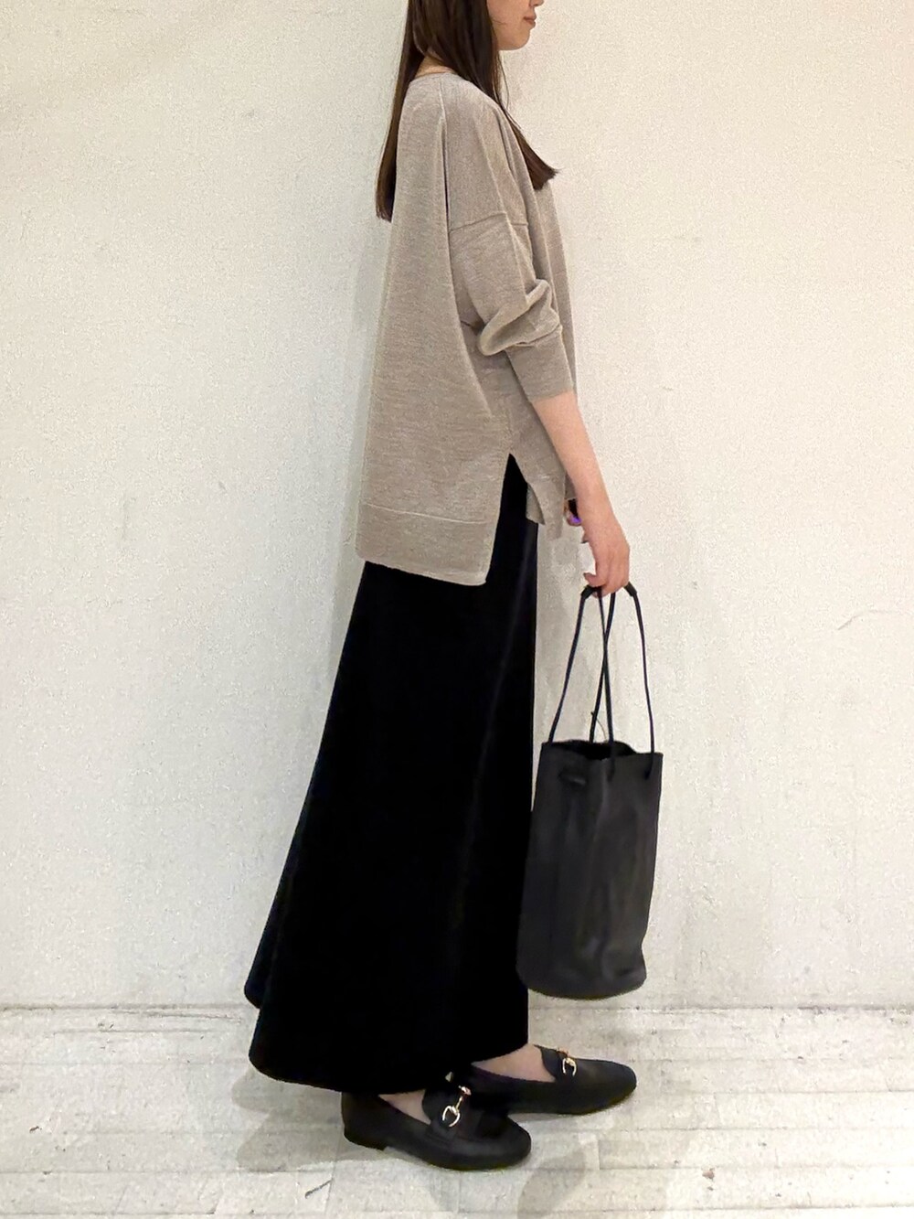 ベージュ系のニット/セーター、ベージュ系のニット/セーター、ブラック系のスカートを着用したレディースの秋コーディネートの2枚目の写真