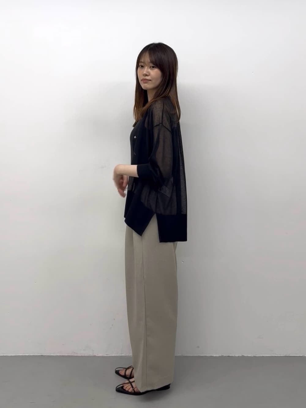 ブラック系のニット/セーター、ブラック系のサンダル、ベージュ系のその他パンツを着用したレディースの夏コーディネートの4枚目の写真
