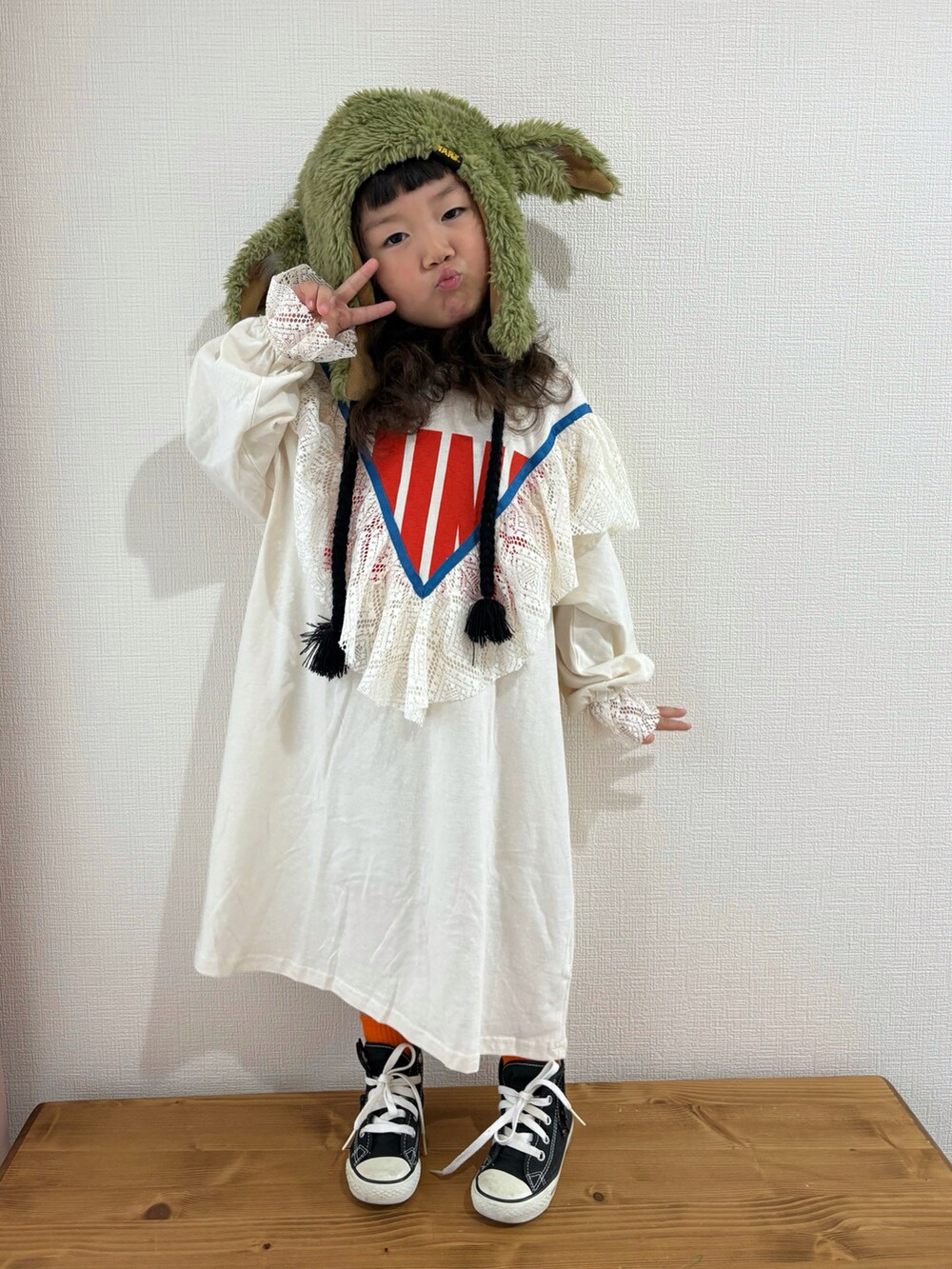 ホワイト系のワンピース、ホワイト系のスニーカーを着用したキッズの冬コーディネートの2枚目の写真
