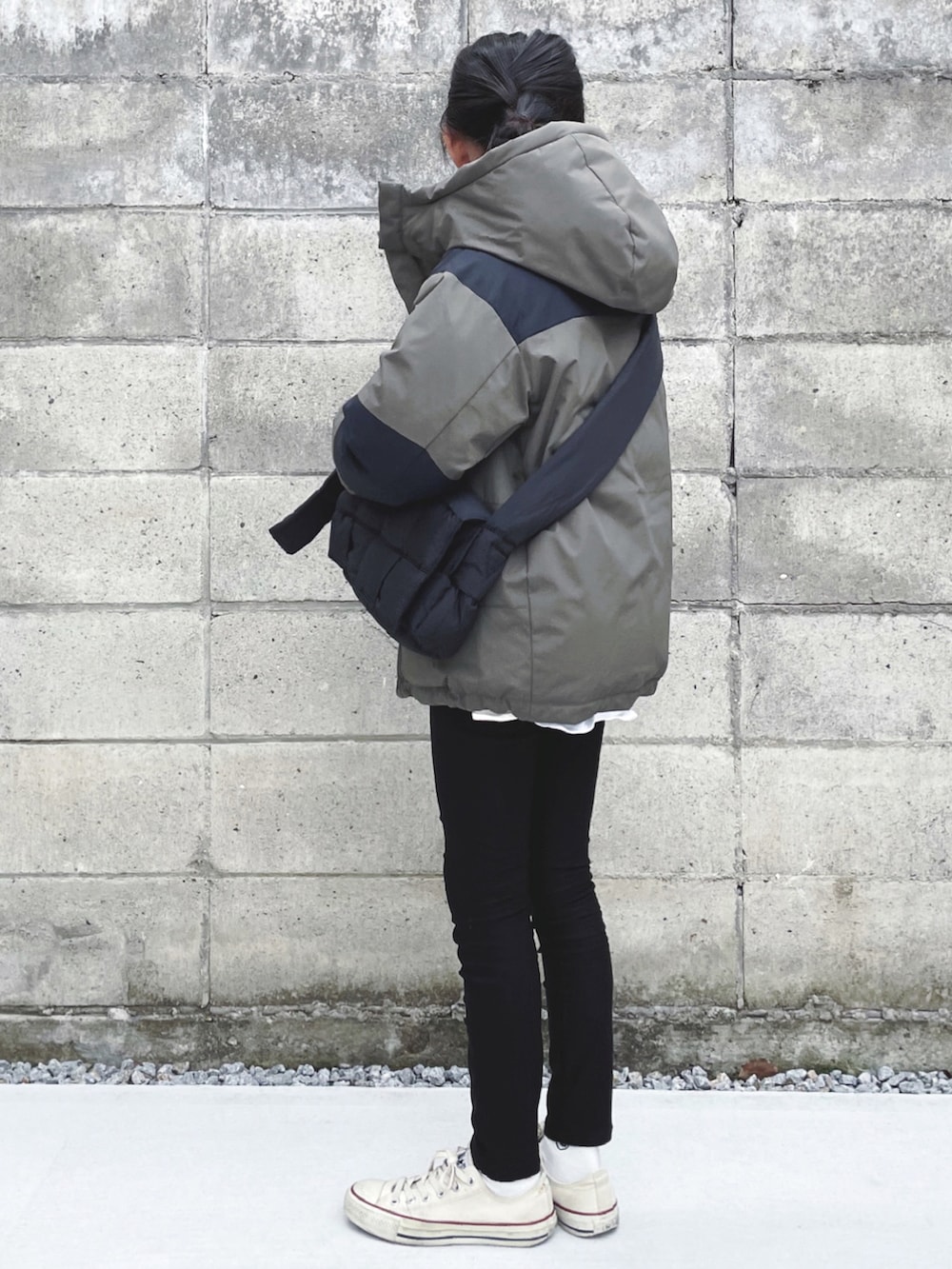 グリーン系のダウンジャケット/コート、ブラック系のショルダーバッグ、ブラック系のその他パンツを着用したキッズの冬コーディネートの2枚目の写真