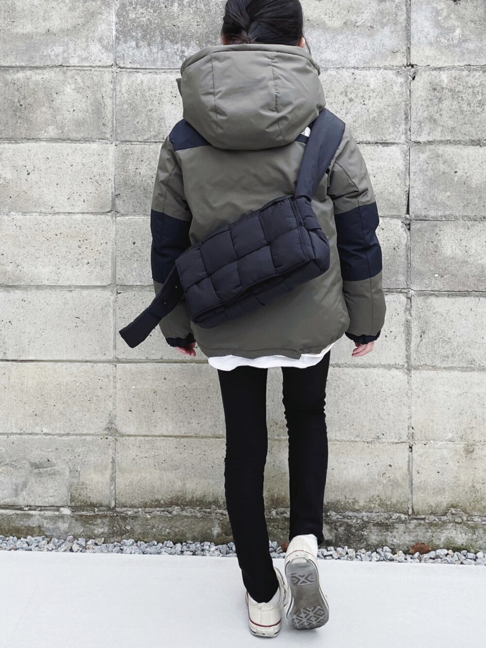 グリーン系のダウンジャケット/コート、ブラック系のショルダーバッグ、ブラック系のその他パンツを着用したキッズの冬コーディネートの4枚目の写真