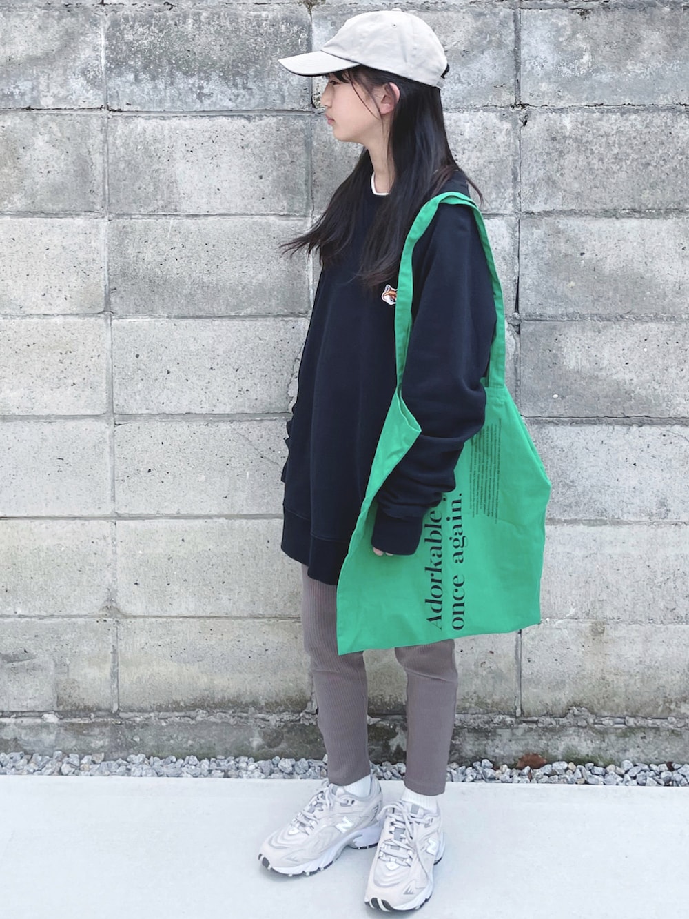 ブラック系のスウェット、グリーン系のエコバッグ/サブバッグ、ベージュ系のスニーカーを着用したキッズの冬コーディネートの2枚目の写真