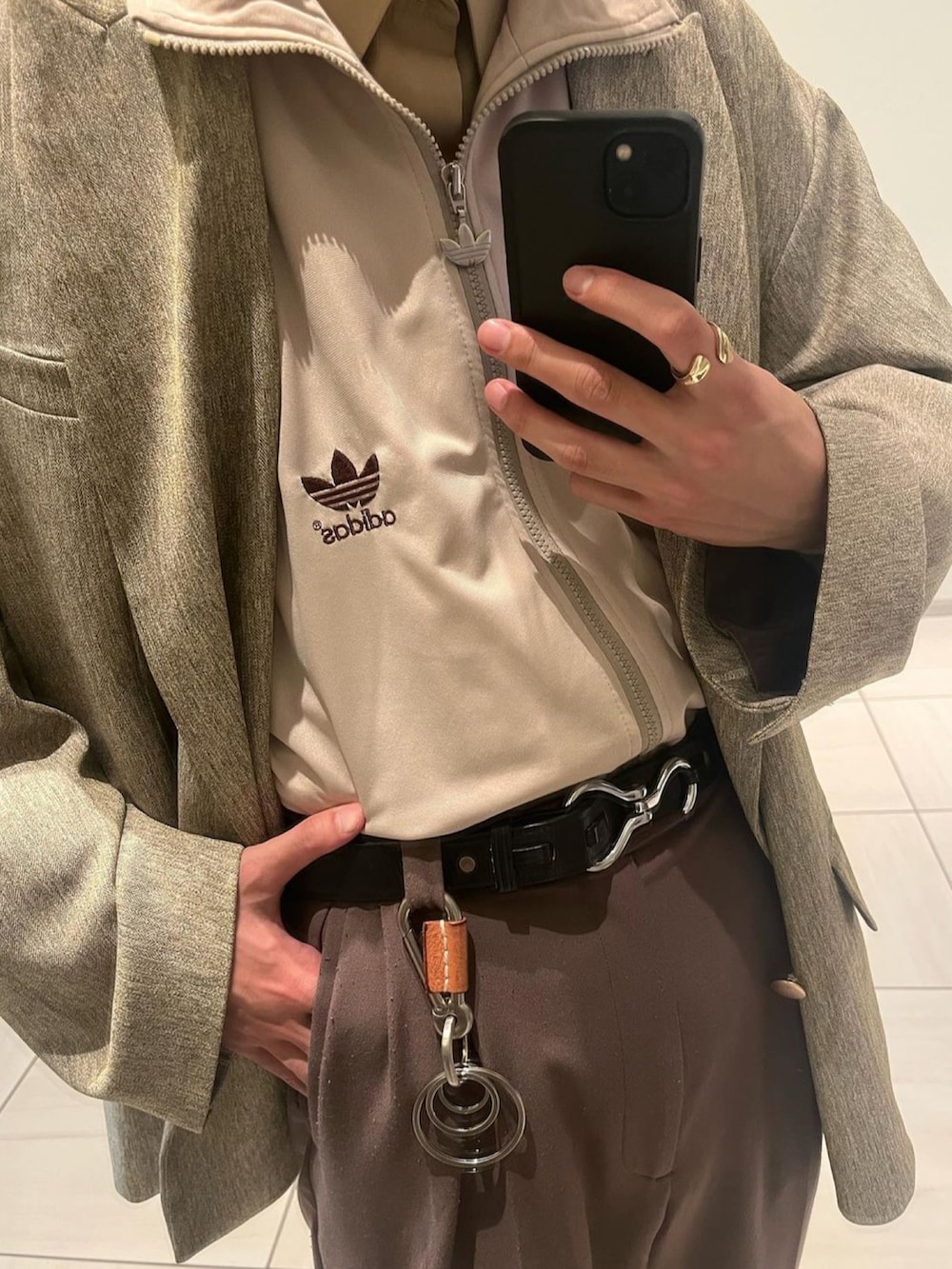 イエロー系のテーラードジャケット、ブラウン系のスラックス、ベージュ系のジャージを着用したメンズの秋コーディネートの3枚目の写真