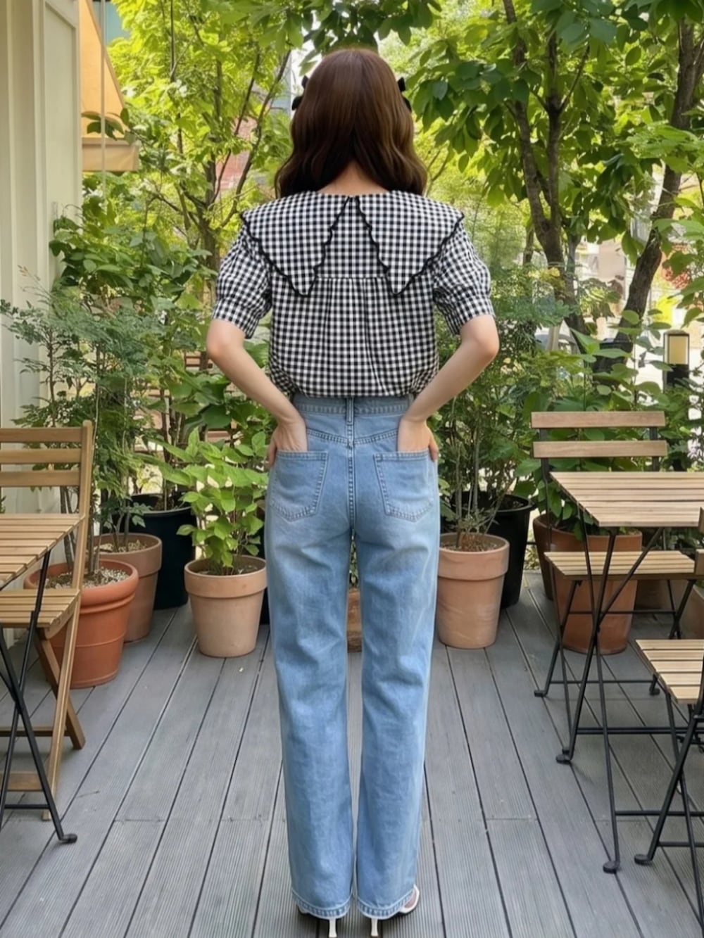 ブラック系のトップス、ブルー系のパンツを着用したレディースの夏コーディネートの2枚目の写真