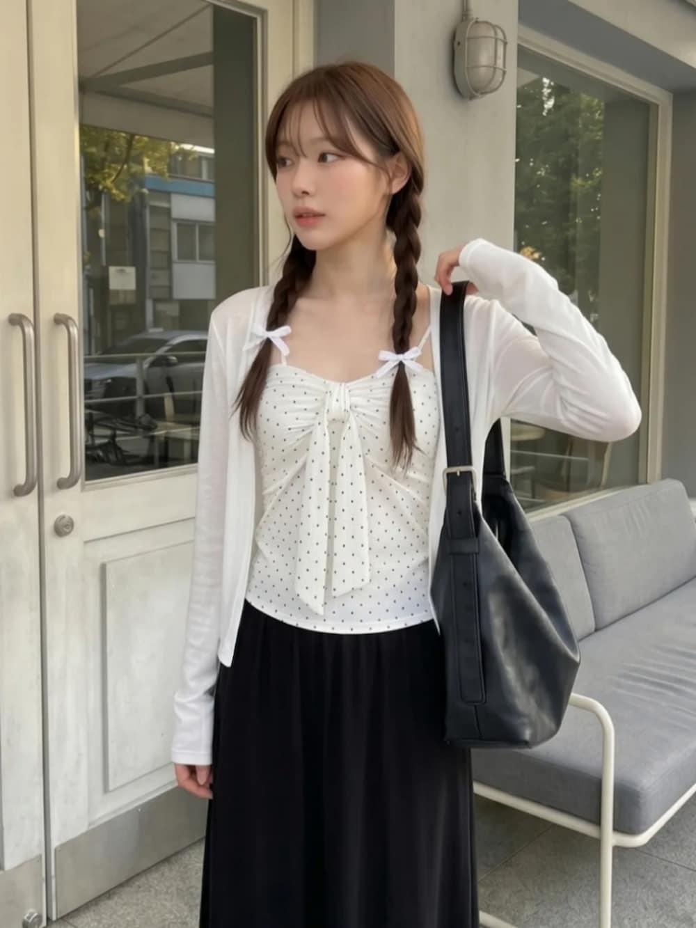 ホワイト系のトップス、ブラック系のスカートを着用したレディースの夏コーディネートの2枚目の写真