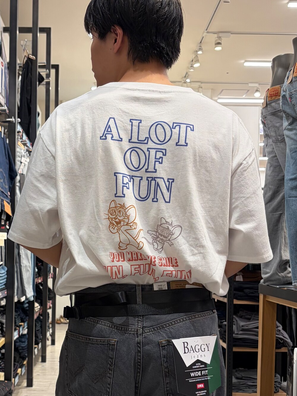 ブラック系のデニムパンツ、ホワイト系のTシャツ/カットソー、ベージュ系のボディバッグ/ウエストポーチを着用したメンズの夏コーディネートの7枚目の写真