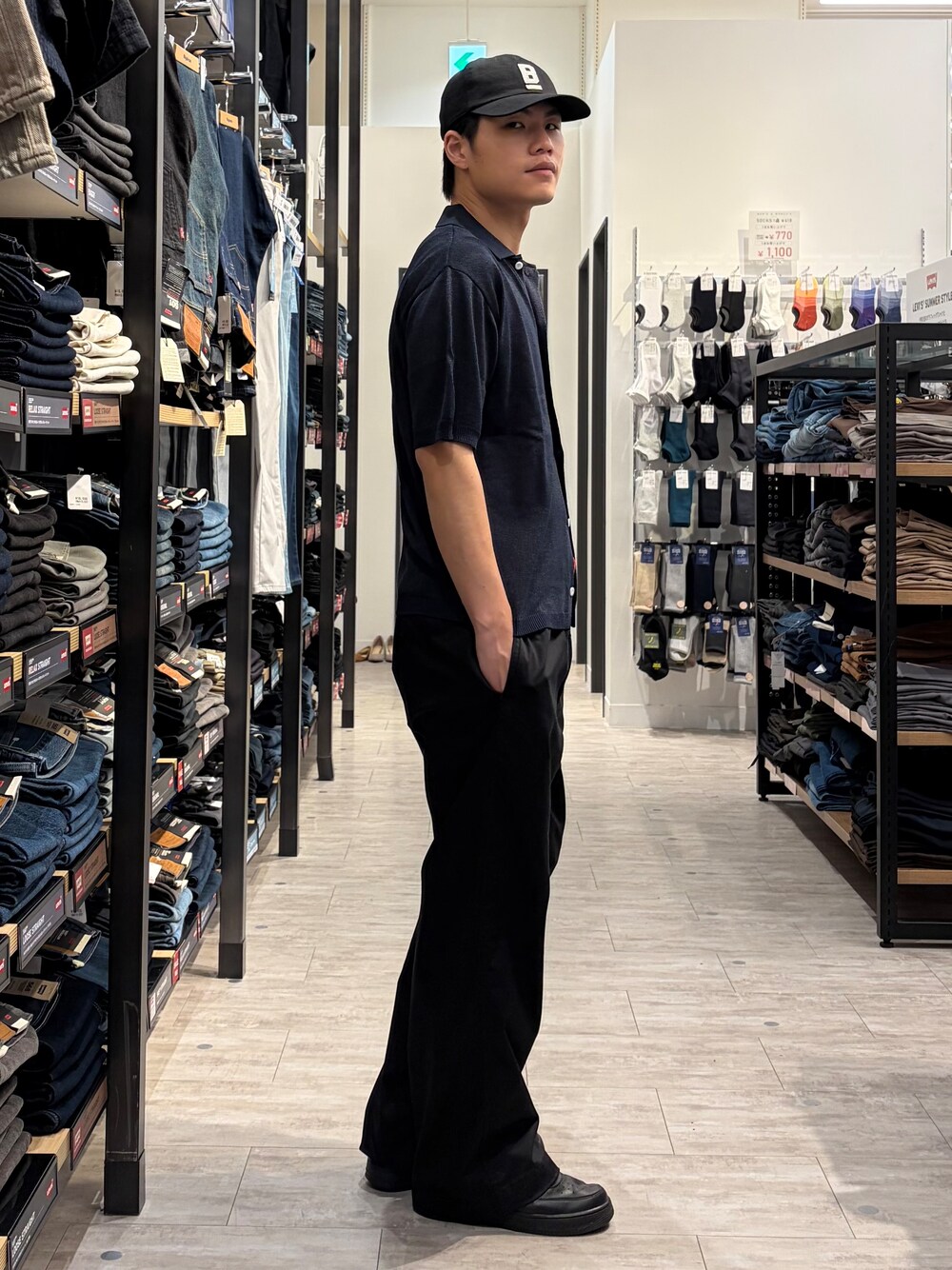 ブルー系のニット/セーター、ブラック系のその他パンツ、ブラック系のキャップを着用したメンズの春コーディネートの3枚目の写真