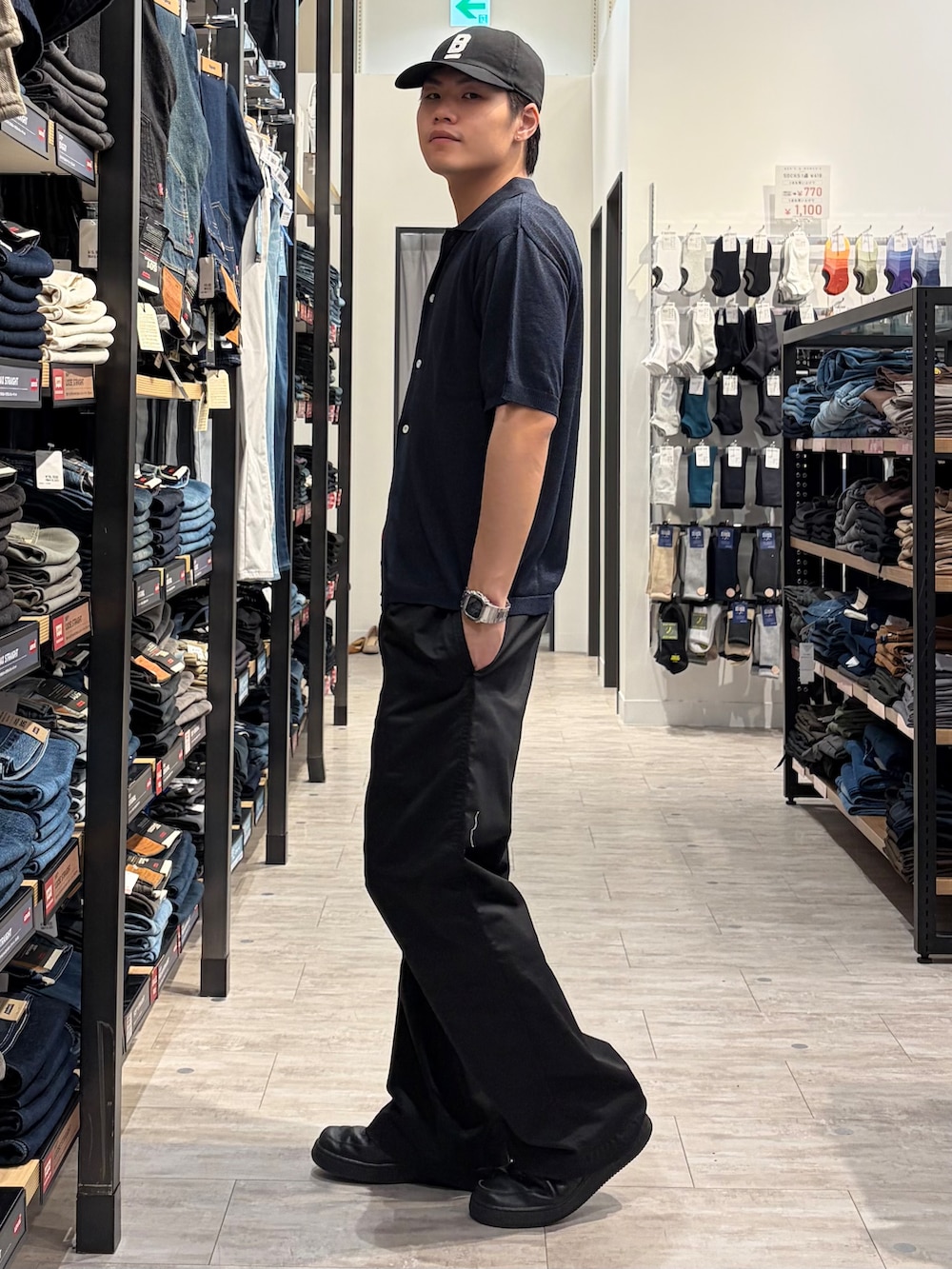 ブルー系のニット/セーター、ブラック系のその他パンツ、ブラック系のキャップを着用したメンズの春コーディネートの2枚目の写真