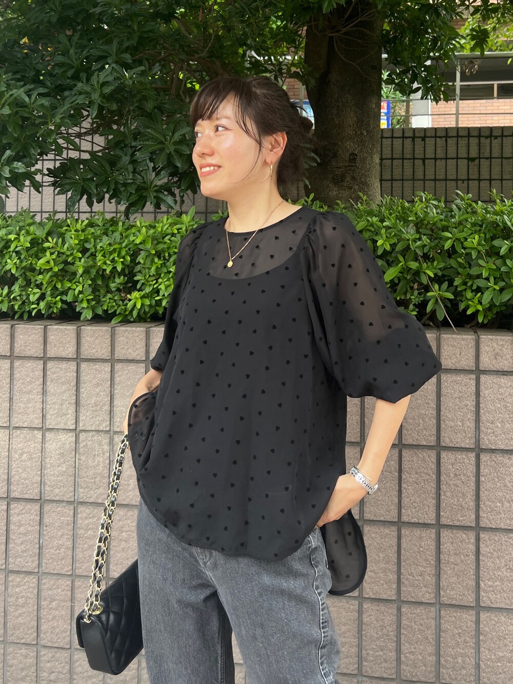 ブラック系のシャツ/ブラウス、ブラック系のショルダーバッグ、ブラック系のデニムパンツを着用したレディースの夏コーディネートの3枚目の写真