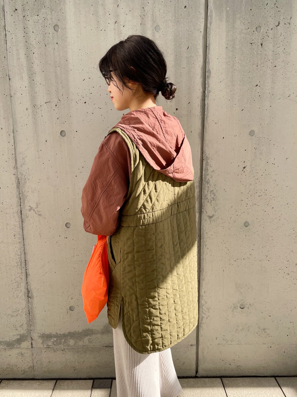 グレー系のスカート、グリーン系のベスト、ブラウン系のブルゾンを着用したレディースの冬コーディネートの5枚目の写真