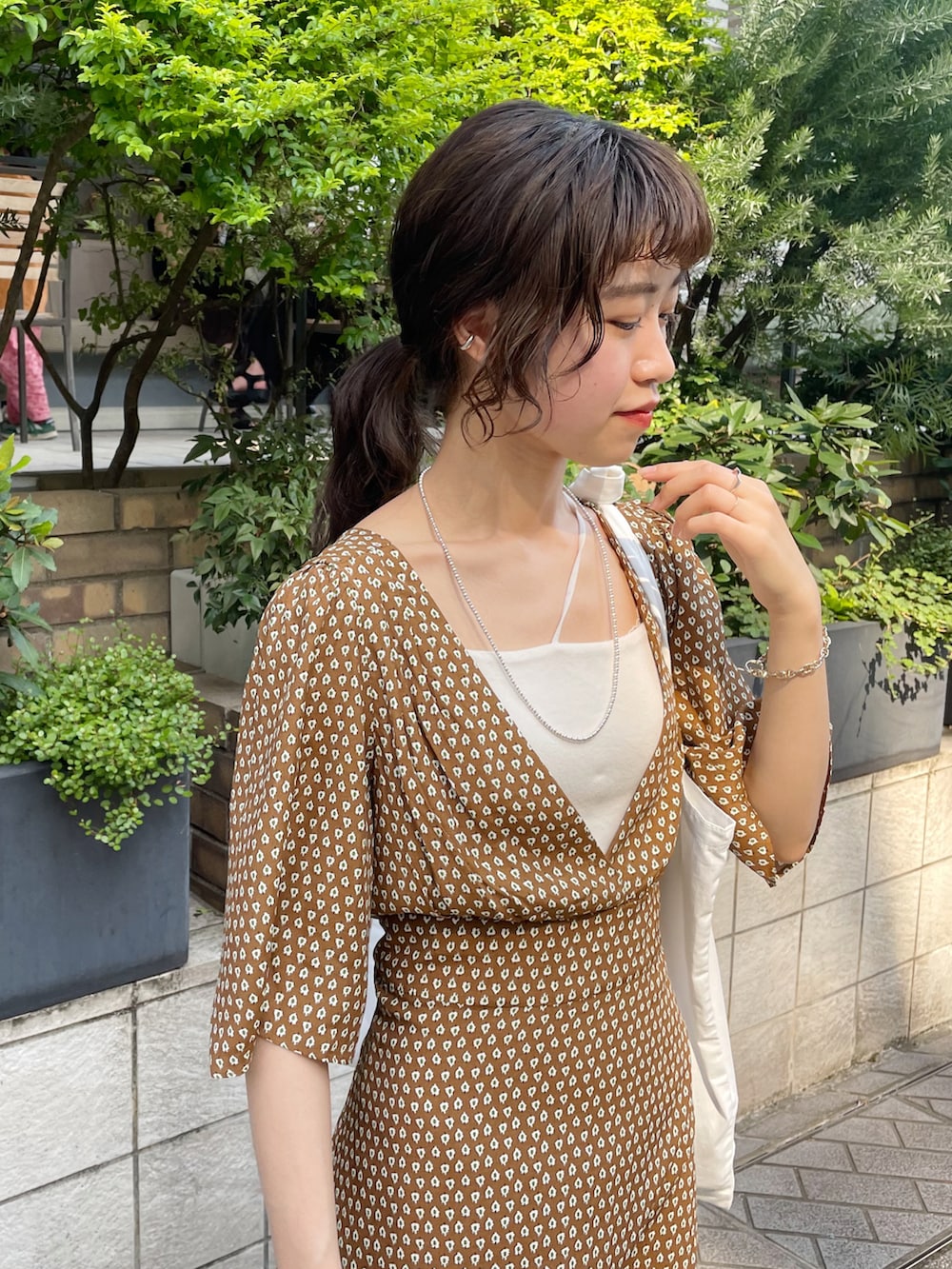 ブラウン系のワンピース、ブラック系のサンダル、ホワイト系のトートバッグを着用したレディースの夏コーディネートの3枚目の写真