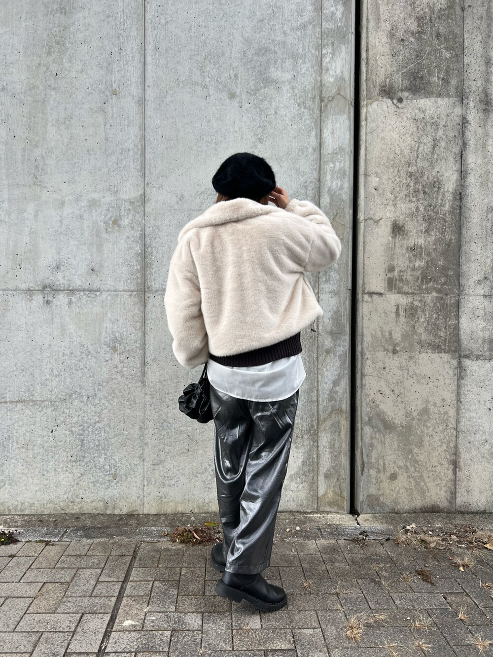 ホワイト系のジャケット/アウター、グレー系のニット/セーター、ホワイト系のシャツ/ブラウスを着用したレディースの冬コーディネートの4枚目の写真